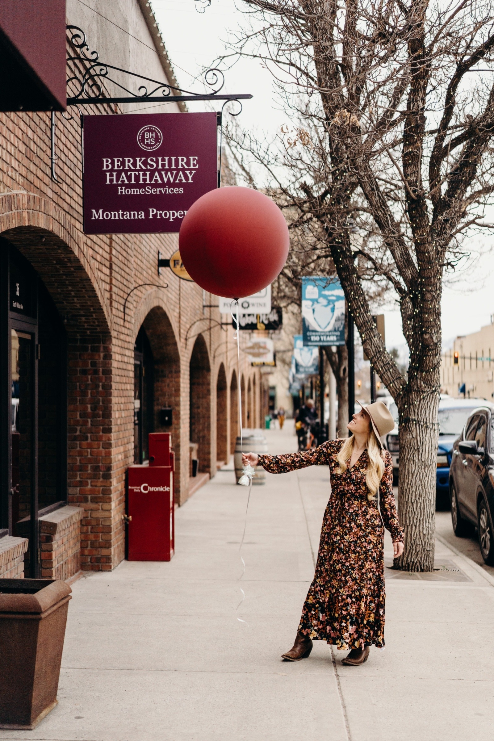 Sarah holding a large balloon outside the office